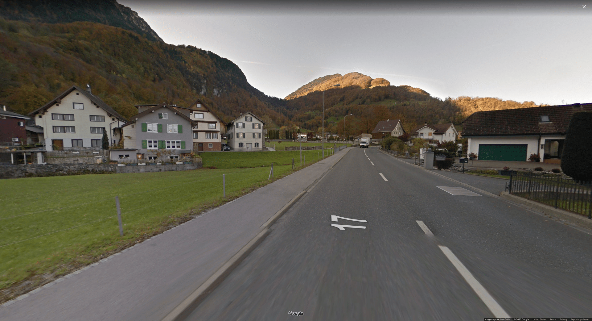 Picture of a small town next to a hillside, with North European/Scandinavian-style houses
